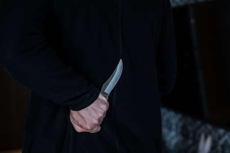 Evil man hold shiny knife, killer in action.の写真素材