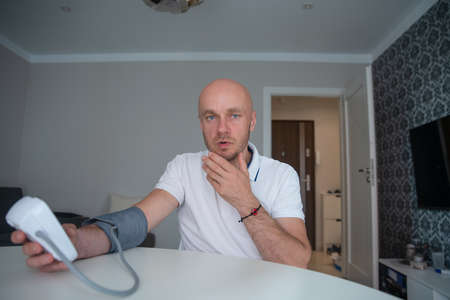 Worried man with high blood pressure. Health and medicine concept.の写真素材