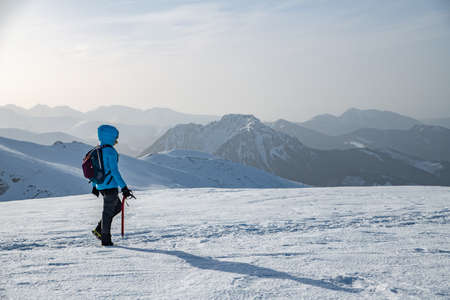 Winter activities, hiking Polish mountains. Climbing the mountain through the snow.の写真素材