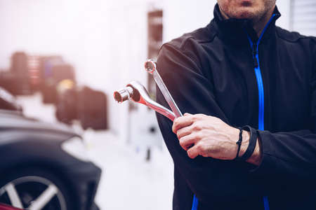 Car service man mechanic holding wrenchの写真素材