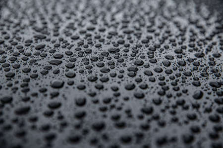 Hydrophobic effect and water drops on car varnish after using ceramic coatingの写真素材