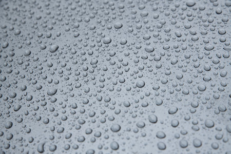 Hydrophobic effect and water drops on car varnish after using ceramic coatingの写真素材
