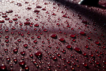Hydrophobic water effect on red car paint after rain.の写真素材