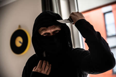 Criminal or bandit holding a knife. Attack on your victim.の写真素材