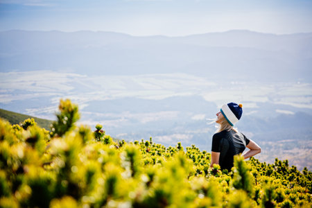 Beautiful blonde woman enjoys the moment on a mountain hike in the Slovak Tatra Mountains
