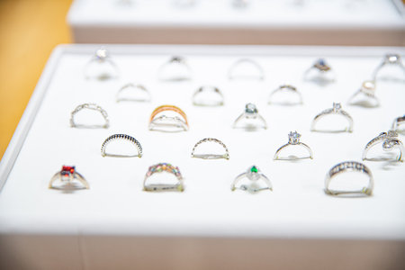 Elegant rings on display, featuring diamonds, gemstones, and intricate designの写真素材