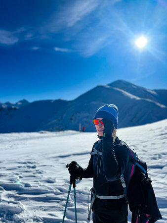 Winter trekker pausing in the serene expanse of the Polish Tatrasの写真素材