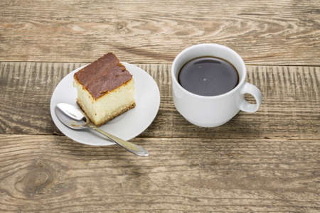Cup of coffee and cake on a wooden table