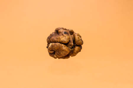 shelled walnuts on a brown background