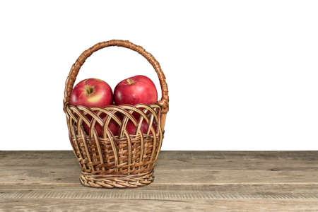 Red apples in the basket on white backgroundの写真素材