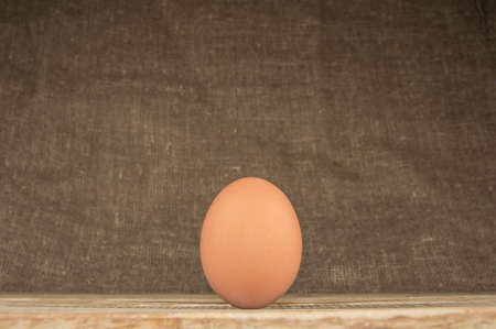 Eggs in a tray on a wooden backgroundの写真素材