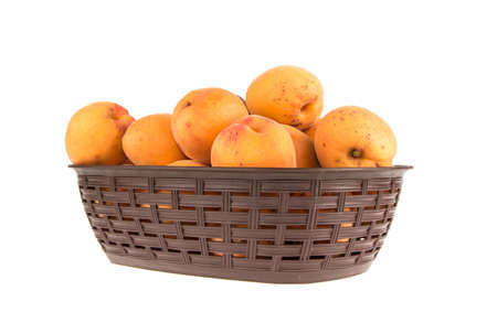 Apricot's in basket on white backgroundの写真素材