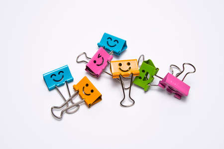 a lot of colorful binder clips on a white backgroundの写真素材