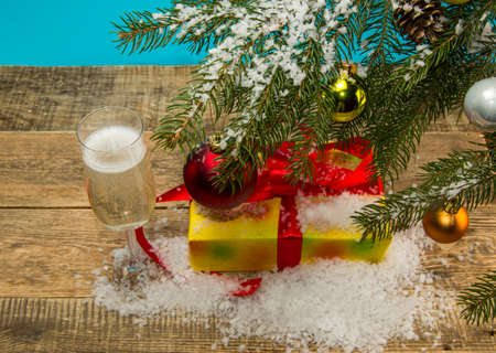 gift under the Christmas tree on a wooden backgroundの写真素材