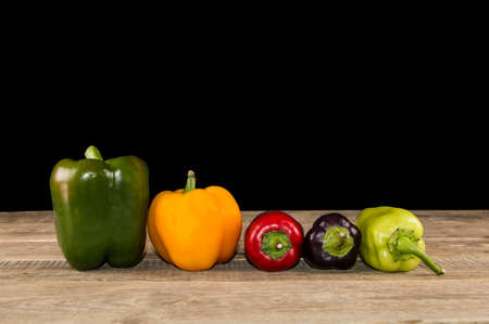 A few peppers on a wooden tableの写真素材