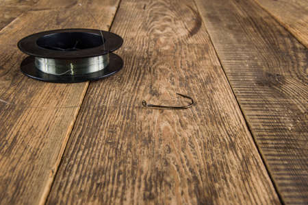 fishing hook on a wooden backgroundの写真素材
