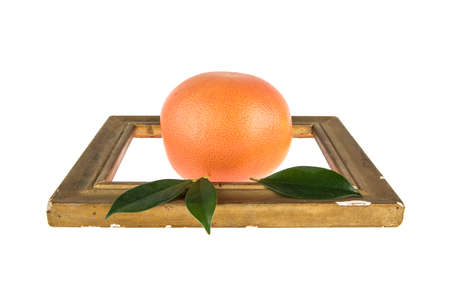 grapefruit and wooden frame on a white backgroundの写真素材