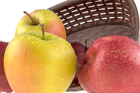wet, clean apples in a basket on a white backgroundの写真素材