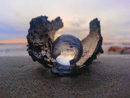 crystal ball on sea sand