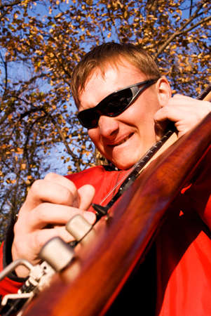 Guitarist plays electric guitar outdoor.の写真素材