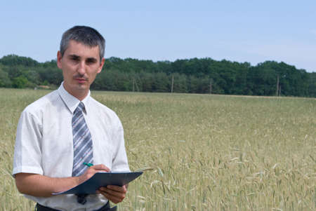 Man inspecting the wheatの写真素材