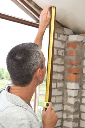 Man measures windowの写真素材
