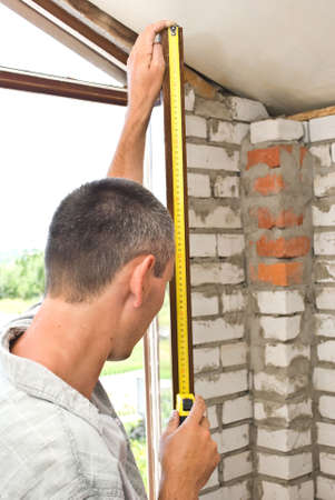 Man measures windowの写真素材