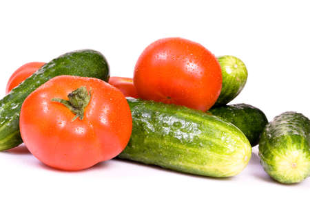 Cucumbers and tomato, isolated on white backgroundの写真素材