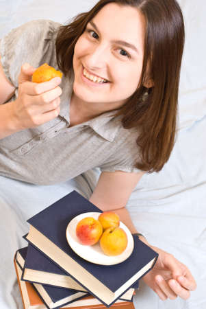 Portrait of young woman with  peach の写真素材