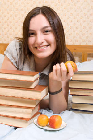 Portrait of young woman with  peach の写真素材