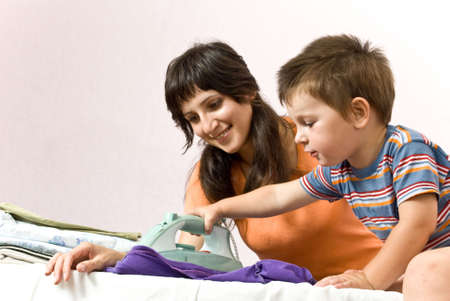 Mother and son ironingの写真素材