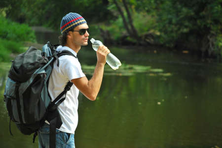 young man drinking bottle of waterの写真素材