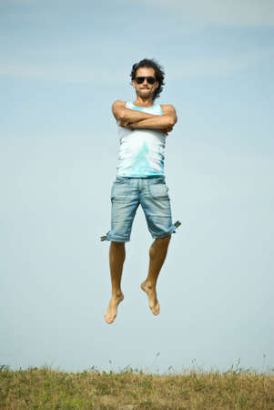 Man jumping on sky backgroundの写真素材
