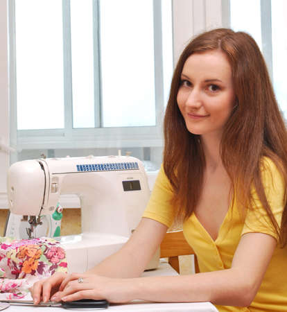 Woman seamstress work on the sewing-machineの写真素材