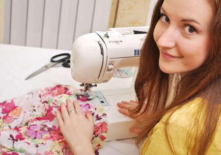 Woman seamstress work on the sewing-machineの写真素材