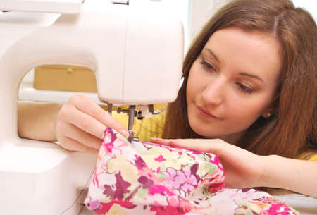 Woman seamstress work on the sewing-machineの写真素材