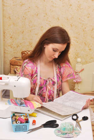 Woman seamstress work on the sewing-machineの写真素材