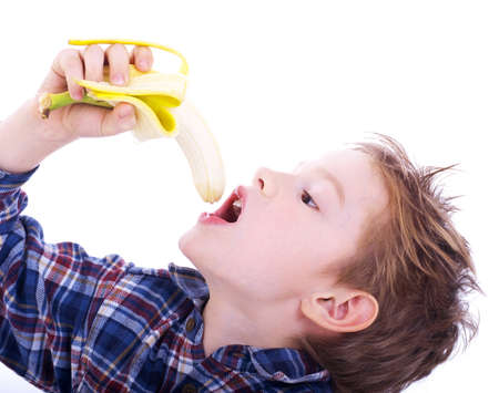 boy with banana isolated on whiteの写真素材