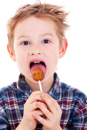 Close Up of Young Boy Eating A Lollipop.の写真素材