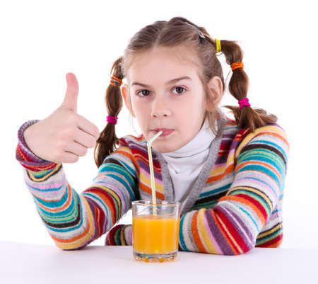 little girl drinking orange juiceの写真素材