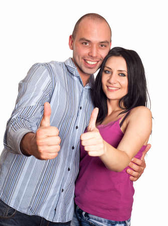 Two young smiling people with thumbs-up gesture isolated on whiteの写真素材