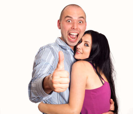 Two young smiling people with thumbs-upの写真素材