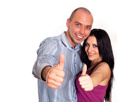 Two young smiling people with thumbs-upの写真素材