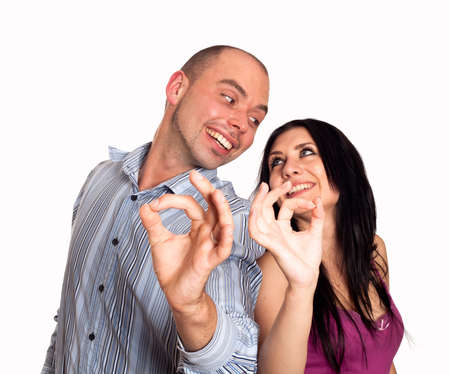 Man and woman  smiling and showing you OK sign の写真素材