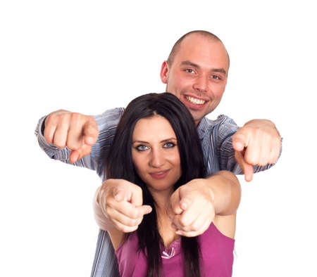 Portrait of happy young couple pointing at you over white backgroundの写真素材