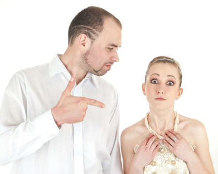 Beautiful smiling wedding couple over white background. Groom pointed at brideの写真素材