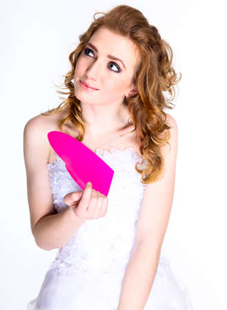 Portrait of happy bride in beautiful dress  with paper heartの写真素材