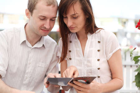 Young couple looking at menu  in cafeの写真素材
