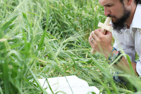 Man praying for good wheat yearの写真素材