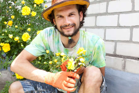 Man cutting the rose bouquet in the gardenの写真素材